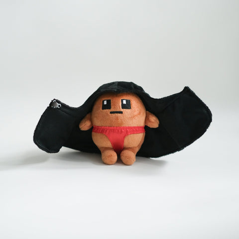 Potatoz plush toy resembling a character with a black cape and red underwear on a white background