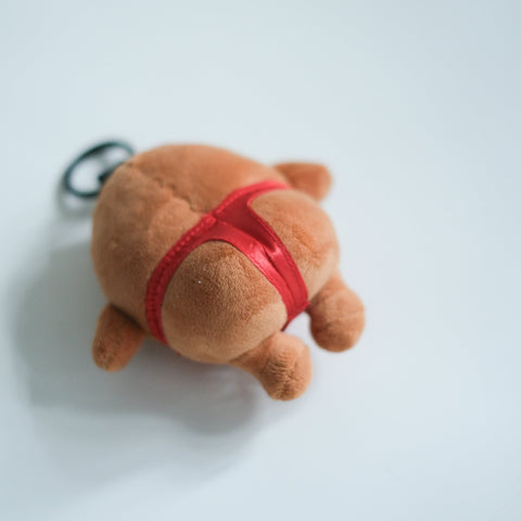 Plush toy with a red t-back on a light gray background