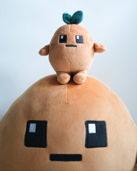Potatoz plush toy sitting on Potatoz cushion