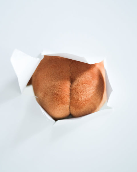 Potatoz butt in a paper wrapper on a light gray background