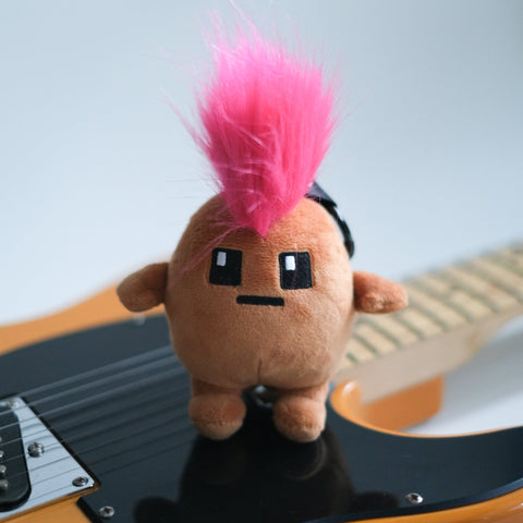 Potatoz plush toy with pink mohawk on a guitar