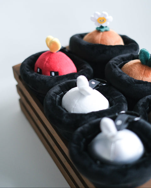 Set of small Potatoz plush toys in black pots on a white background