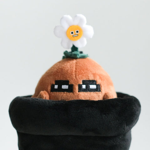 Potatoz plush toy with a black pouch on a white background