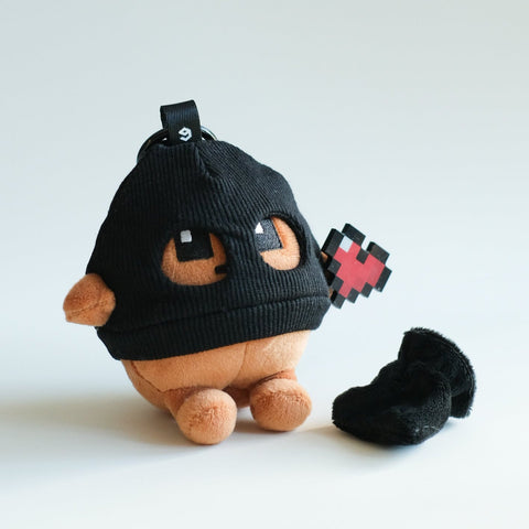 Plush toy with a black hood and red accents on a white background